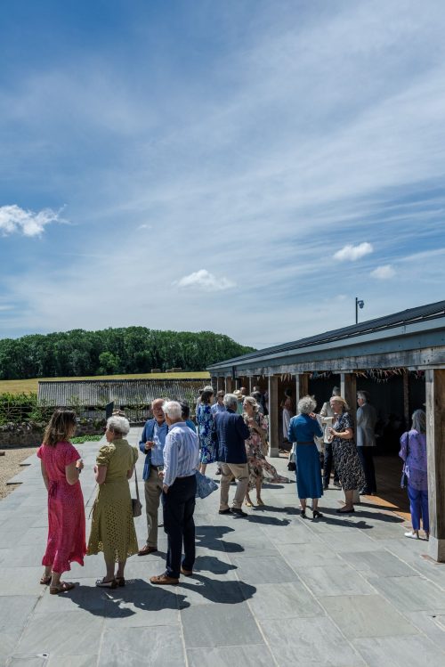 guests enjoy countryside views at barn wedding reception