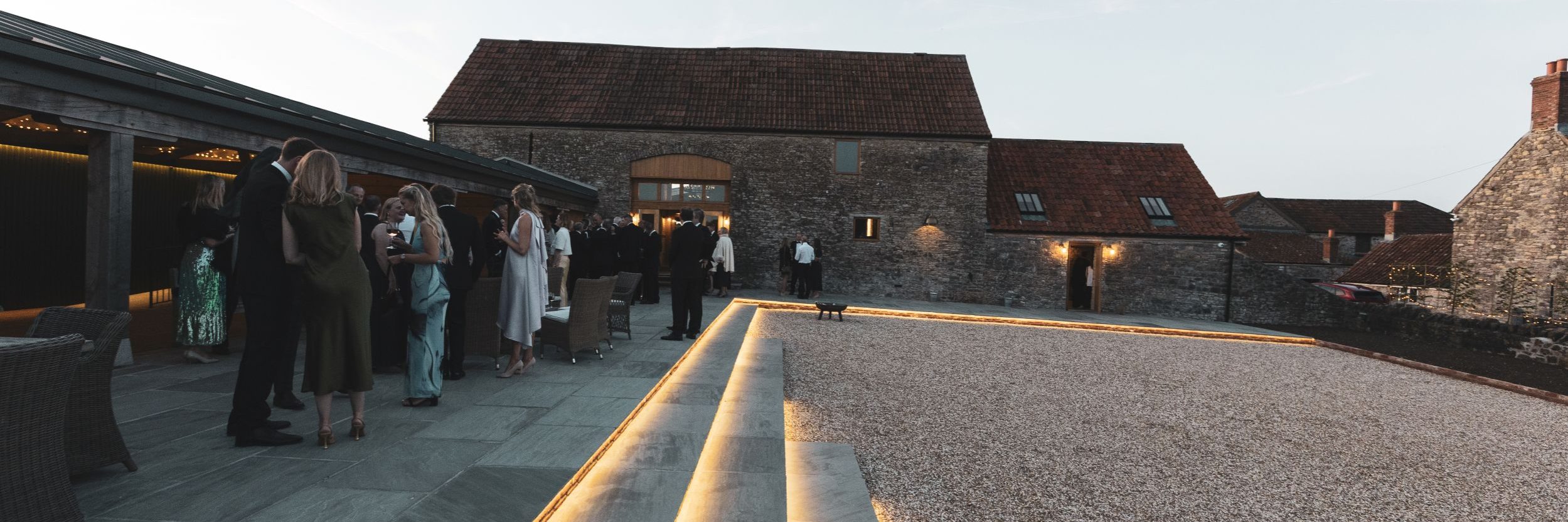 Barn wedding reception guests enjoy drinks on terrace barn wedding reception guests enjoy drinks on terrace