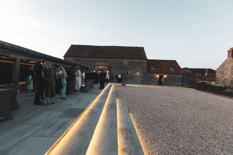 Barn wedding reception guests enjoy drinks on terrace barn wedding reception guests enjoy drinks on terrace